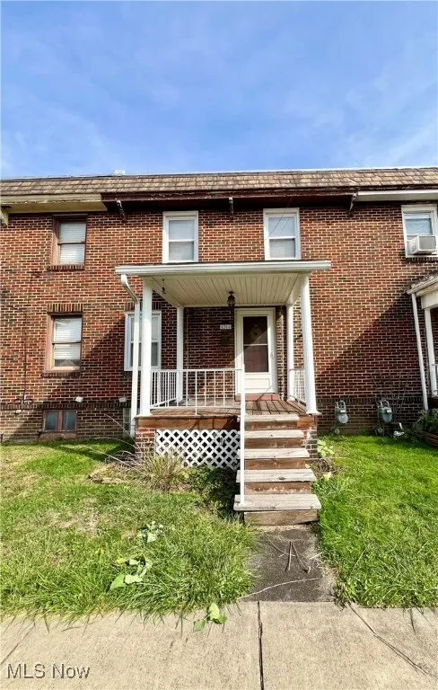View of front of home featuring a porch and a front lawn