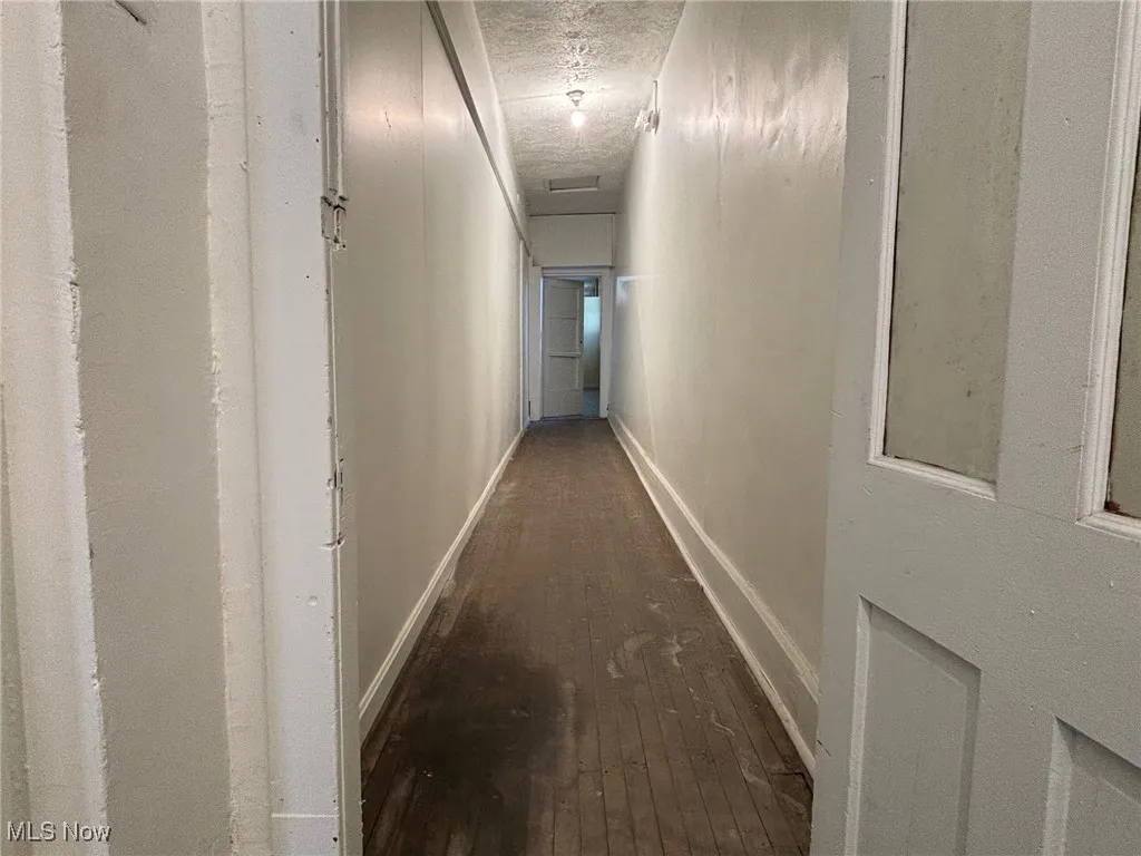 Upstairs hallway with dark wood-type flooring
