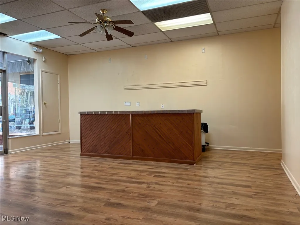 Entry room featuring a paneled ceiling, hardwood / wood-style flooring, and ceiling fan
