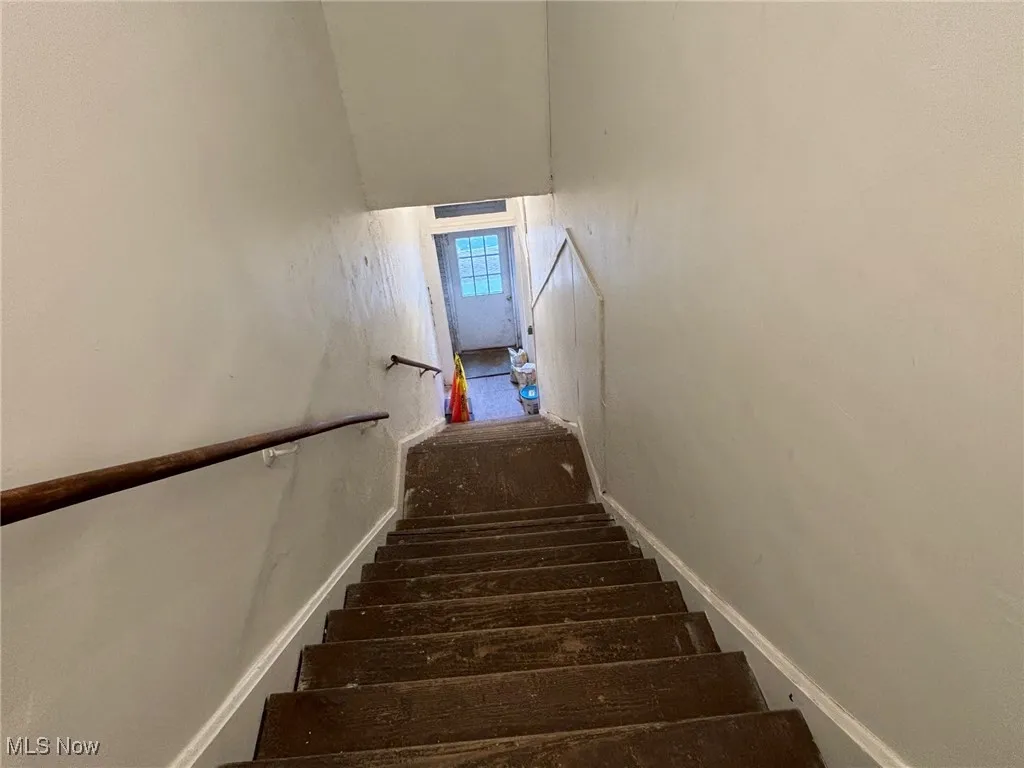 View of stairs from second floor to front secondary entry.