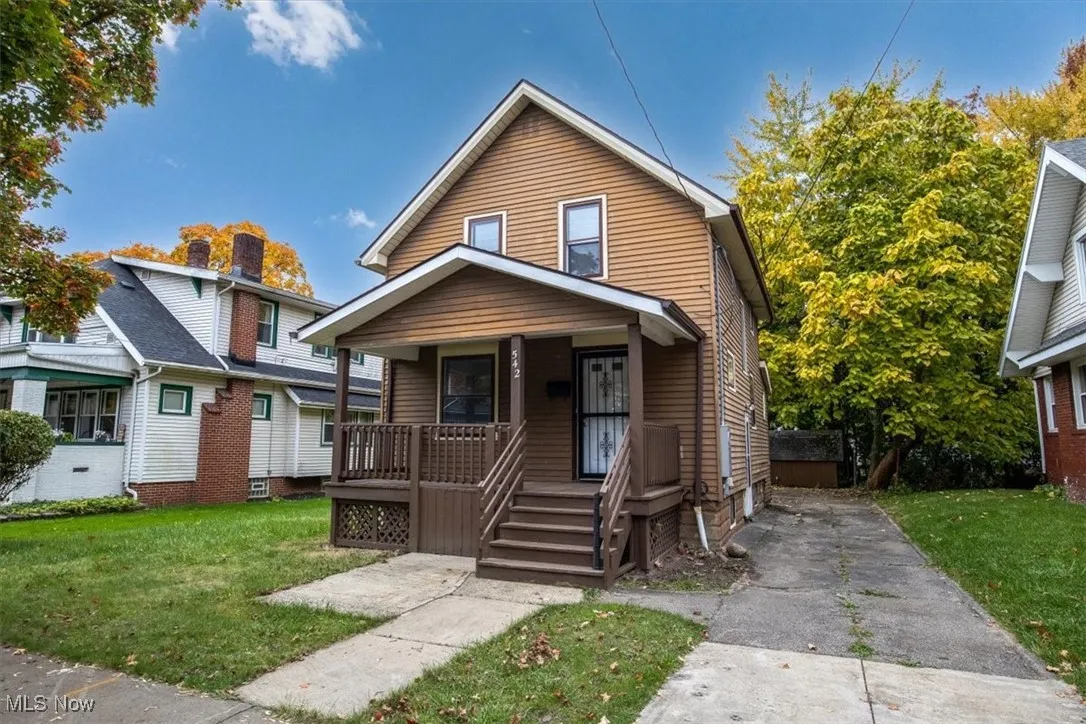 Bungalow with covered porch and a front lawn