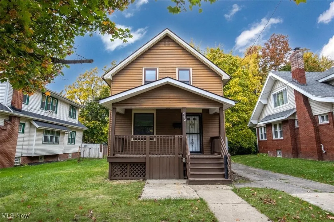 Bungalow-style house with a porch and a front lawn