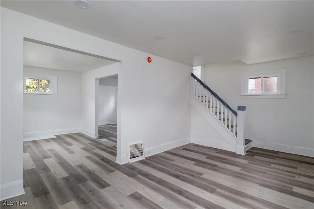 Staircase with plenty of natural light and hardwood / wood-style floors