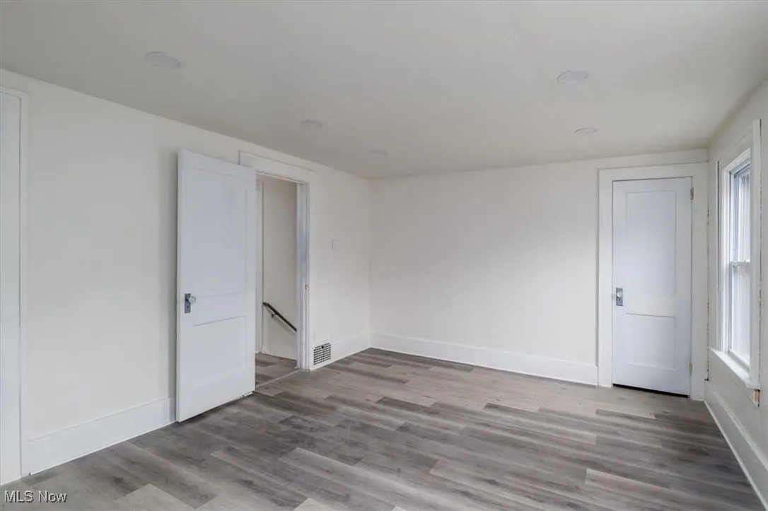 Spare room featuring light hardwood / wood-style floors and a wealth of natural light