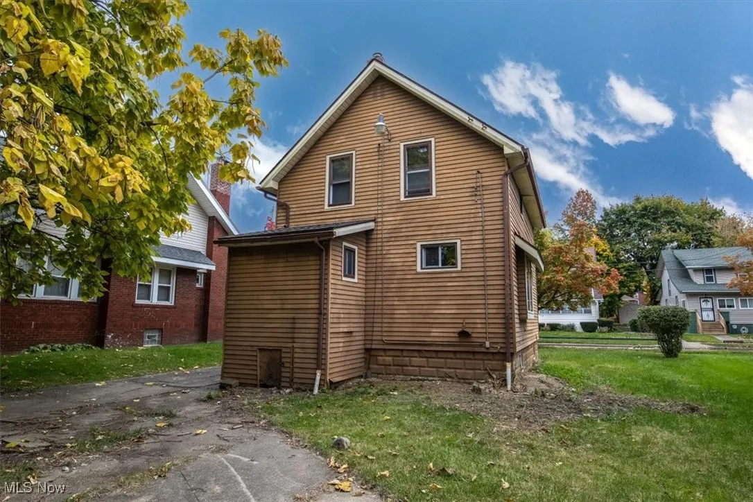 Rear view of house with a yard