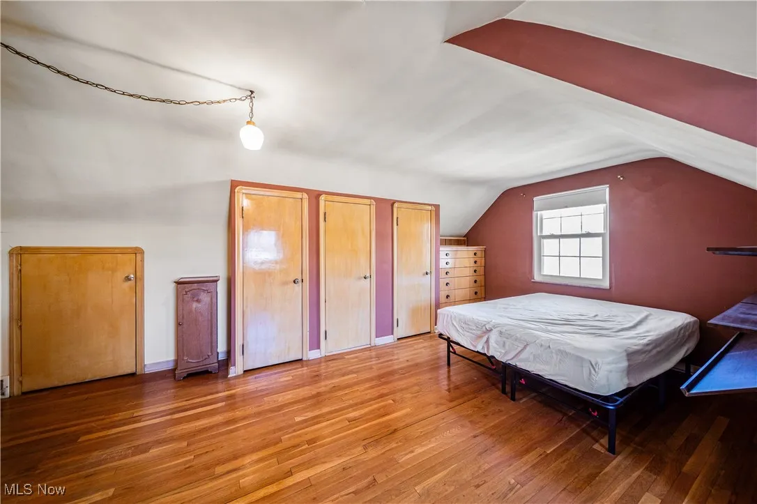 Large upstairs bedroom space with beautiful hardwood floors, built ins and tons of storage.