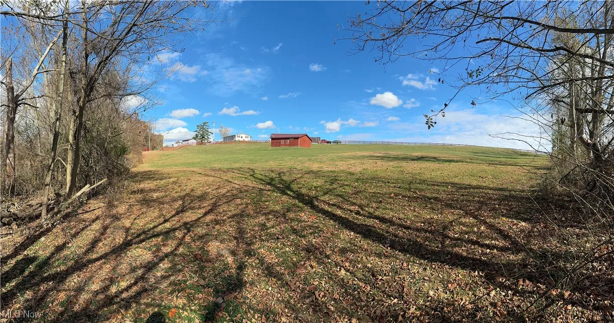 View of rear of property looking at the pasture towards horse barn