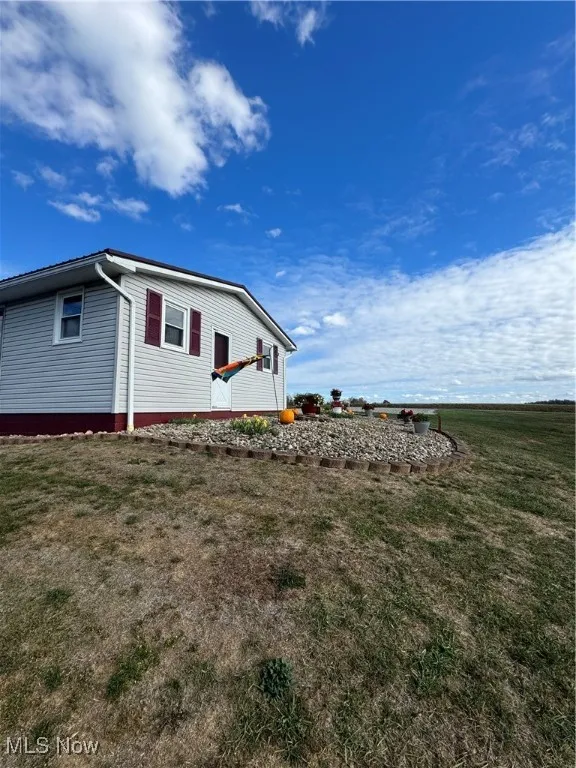 View of side of property with a yard