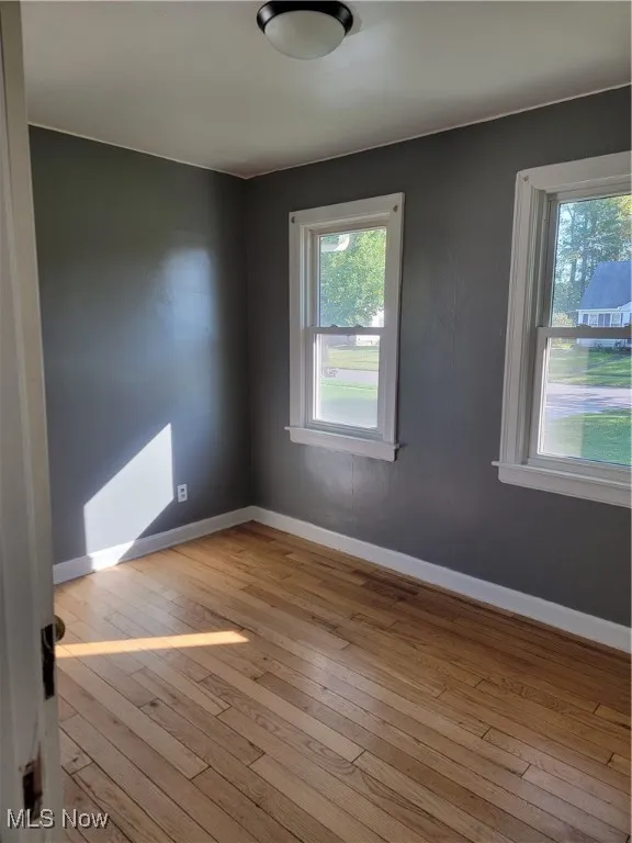Unfurnished room featuring light hardwood / wood-style flooring and plenty of natural light