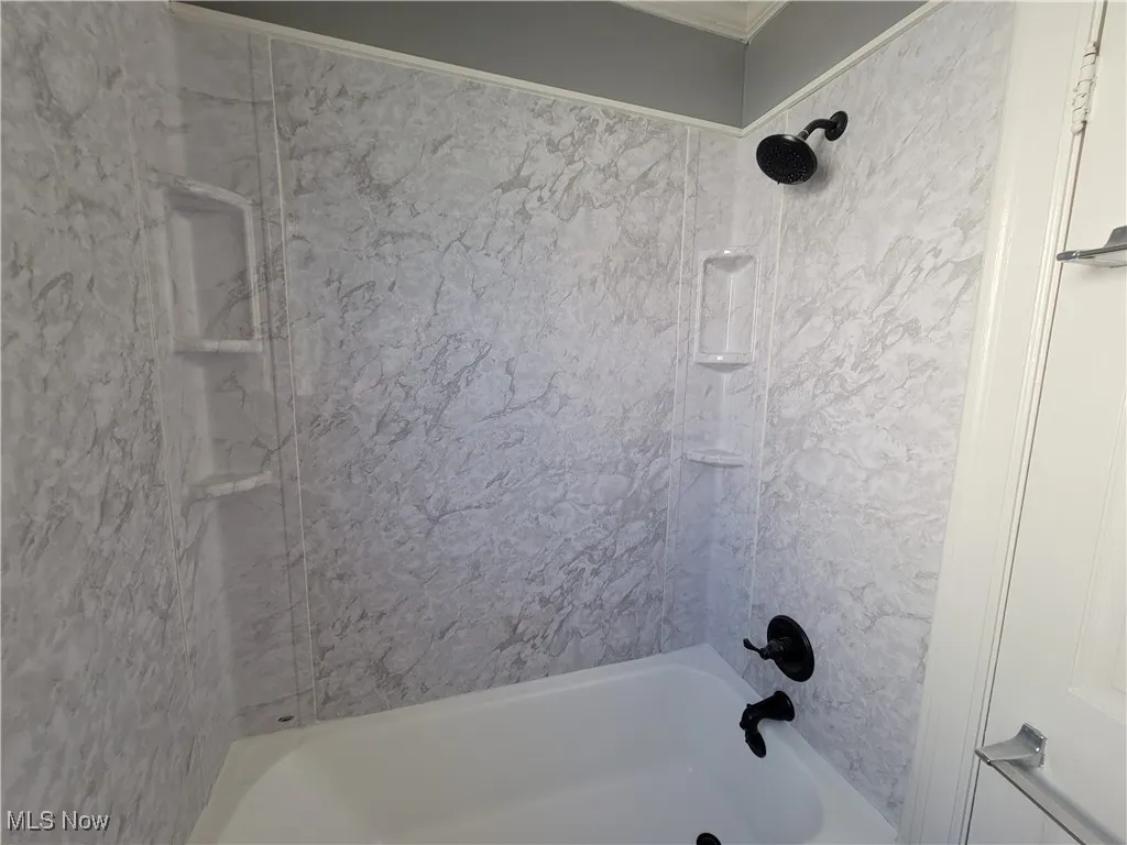 Bathroom featuring new shower surround
