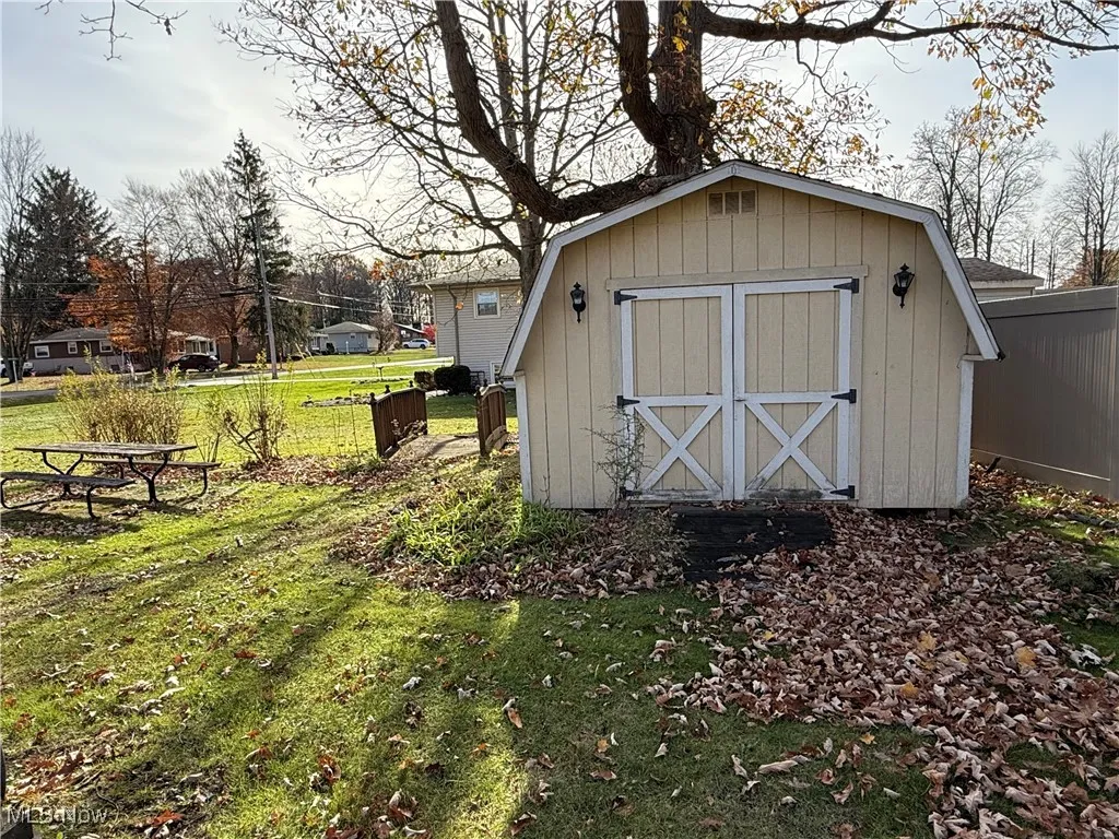 View of outdoor structure with a lawn