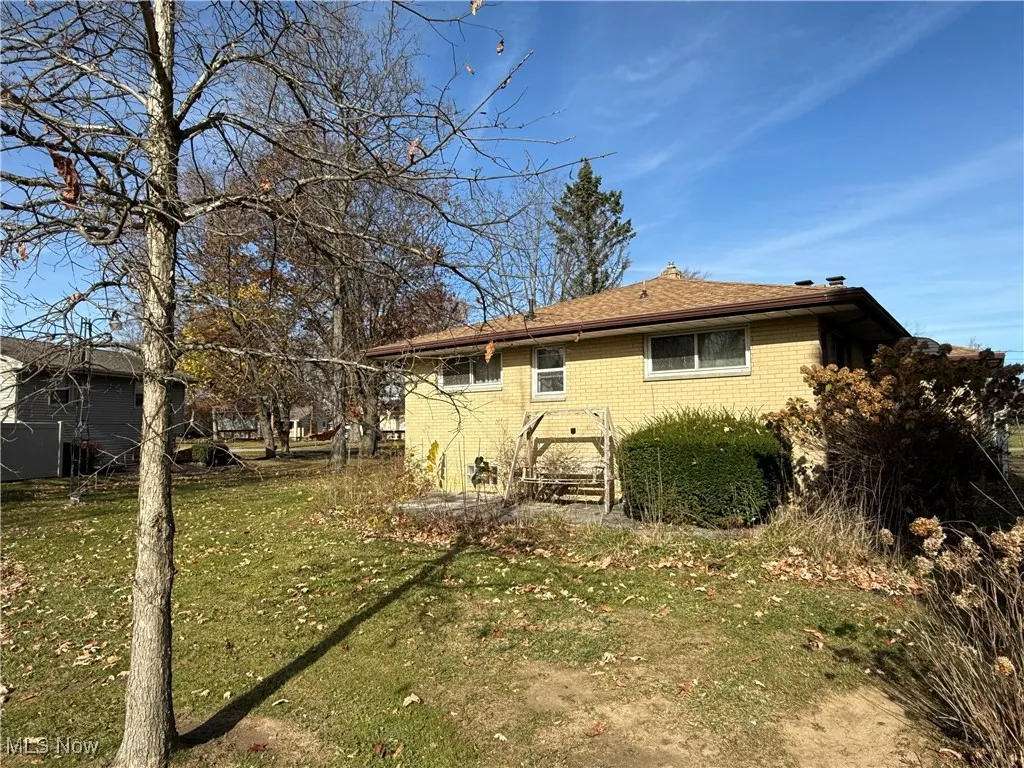 Back of house featuring a yard