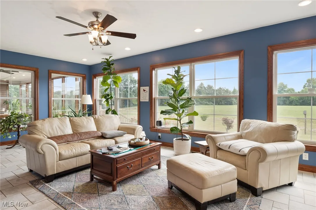 Living room featuring a wealth of natural light and ceiling fan