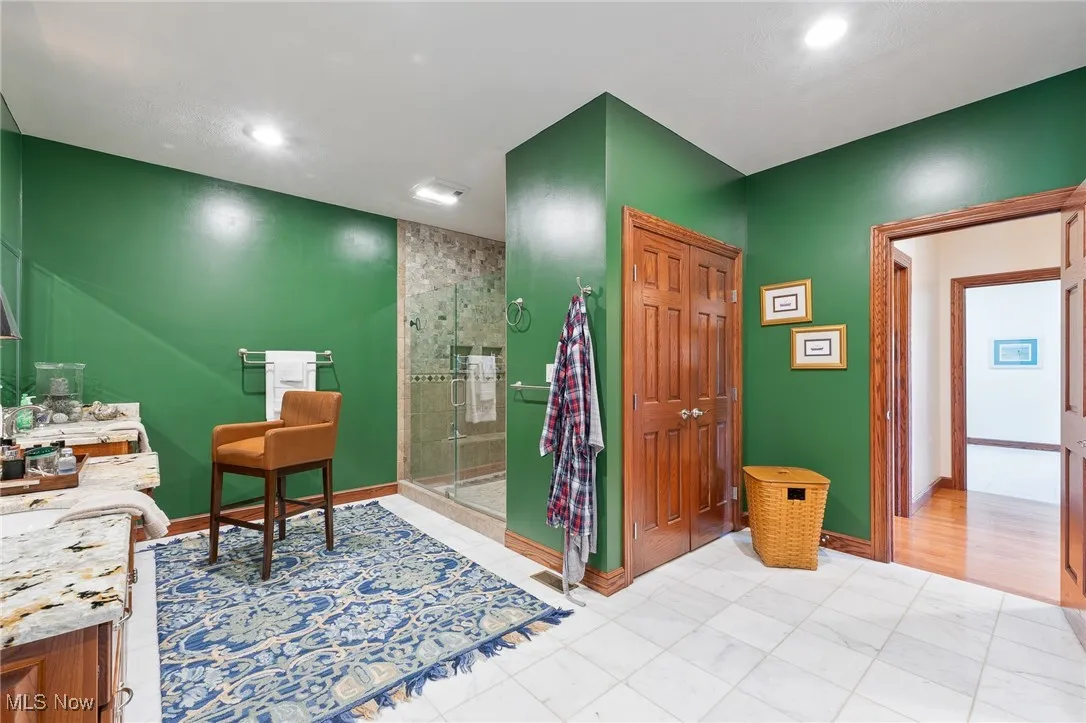Bathroom featuring vanity and a shower with shower door