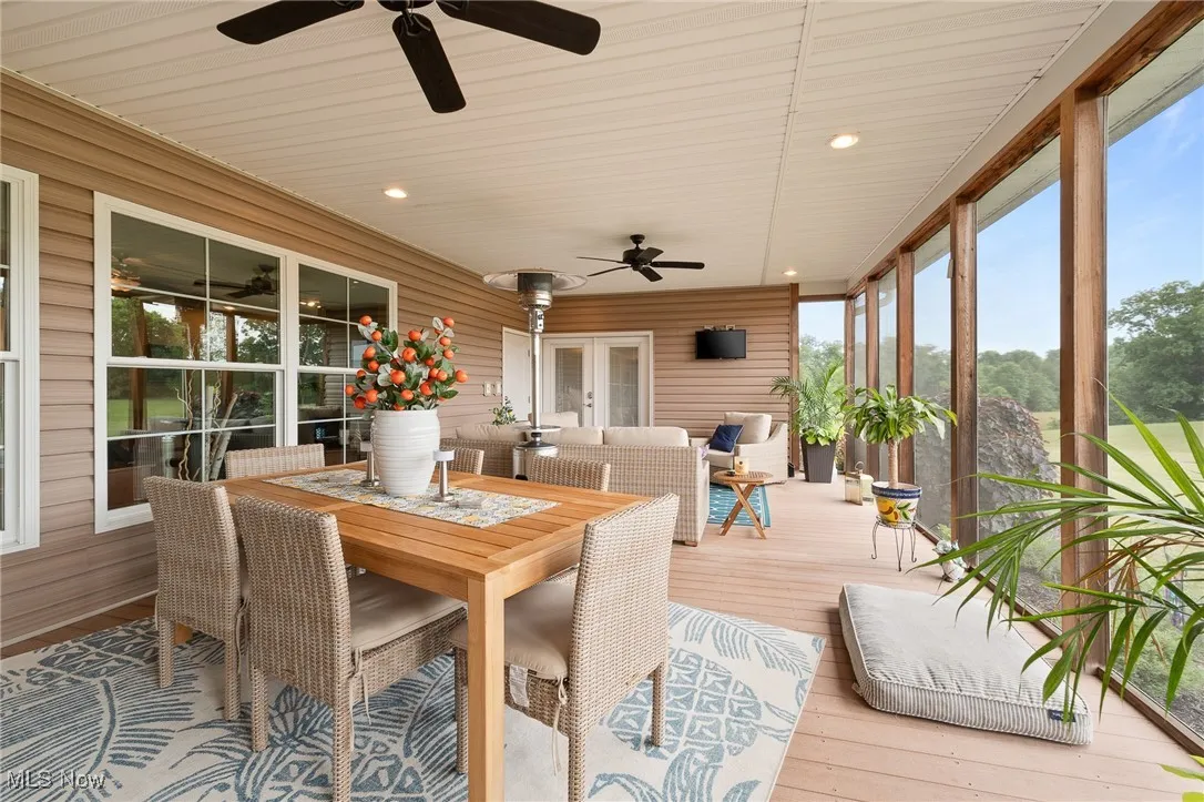 Sunroom with wooden ceiling, ceiling fan, and a healthy amount of sunlight