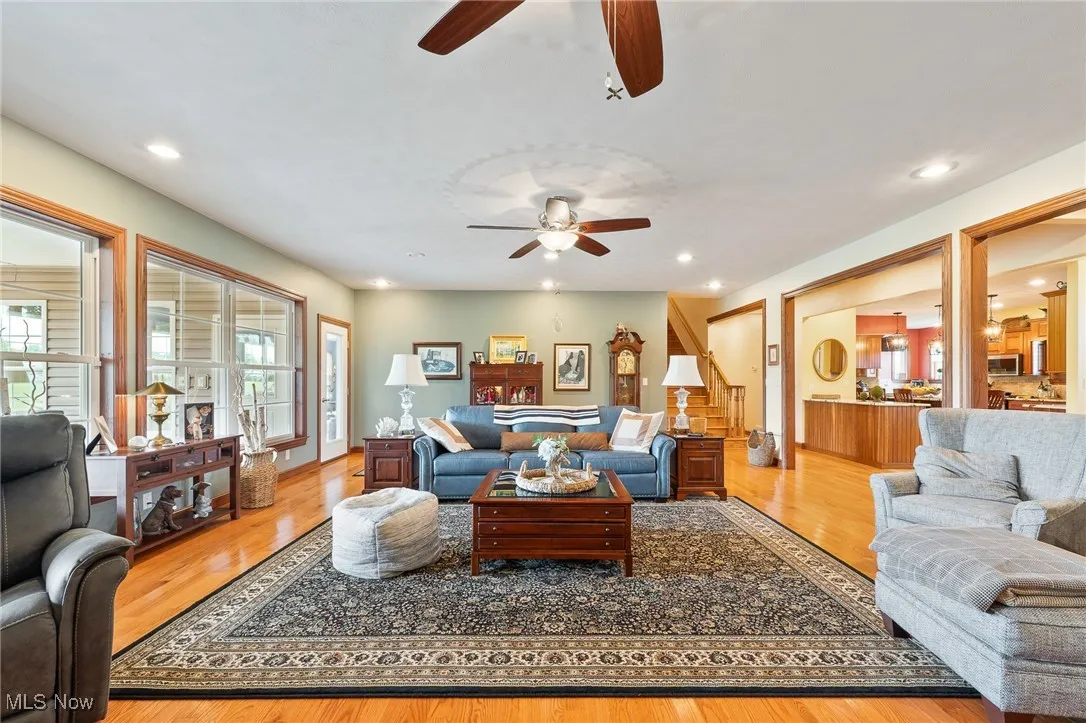 Living room featuring light hardwood / wood-style flooring and ceiling fan