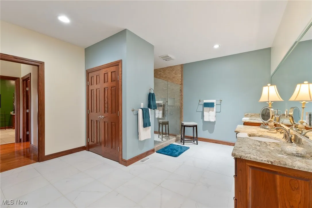 Bathroom featuring vanity and an enclosed shower