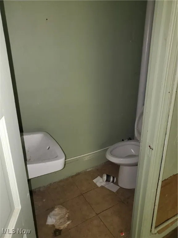 Bathroom featuring tile patterned flooring and toilet