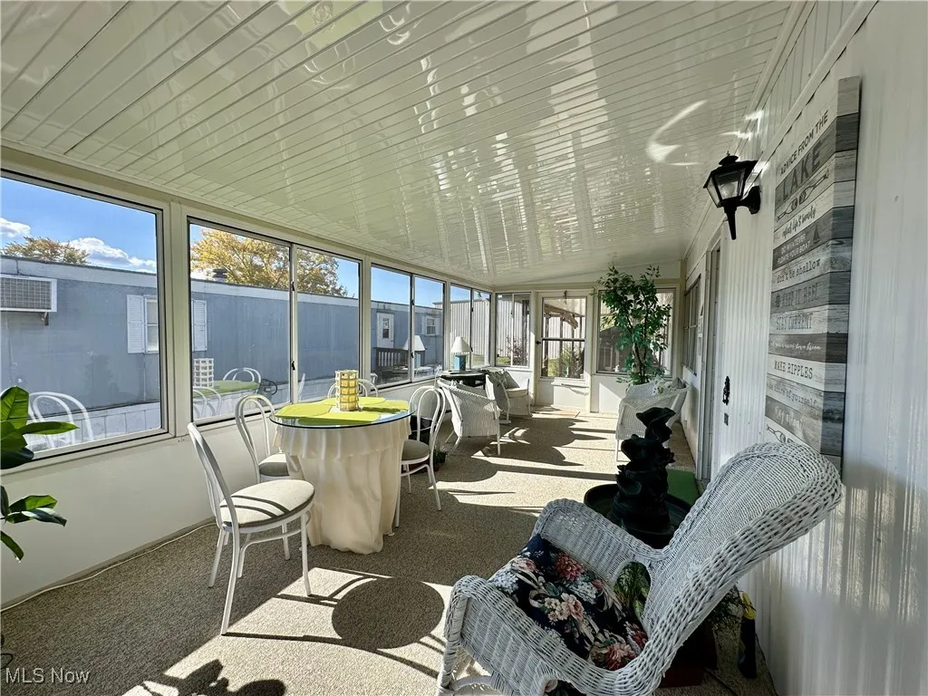 Sunroom / solarium featuring vaulted ceiling