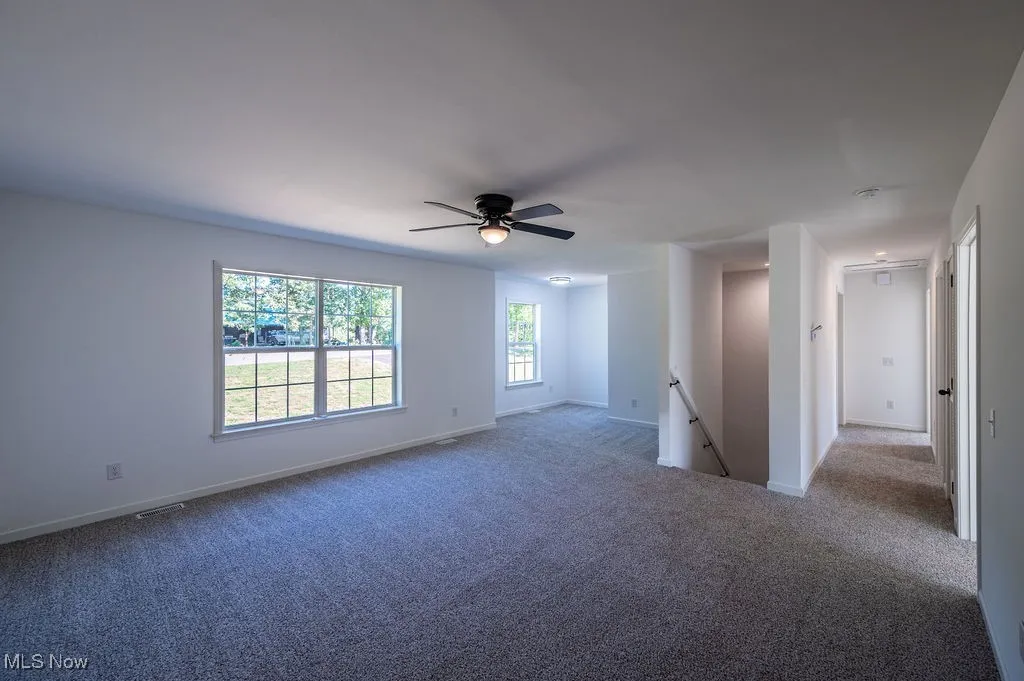 Unfurnished room with carpet floors and ceiling fan