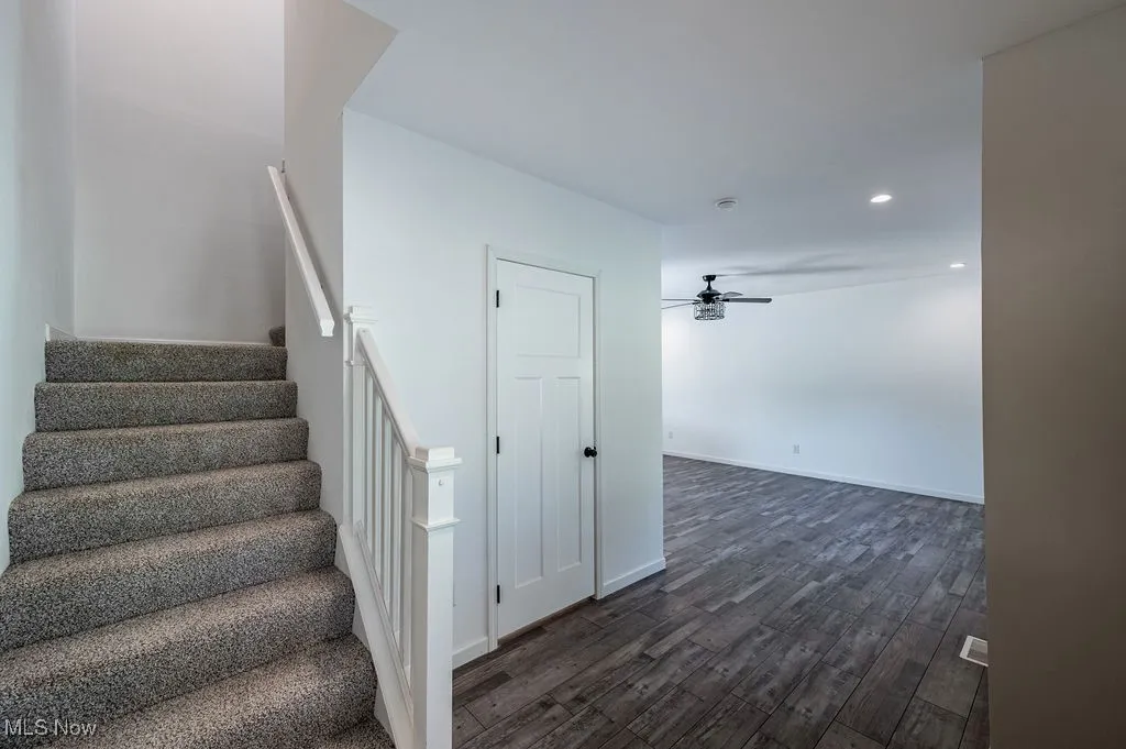 Stairway featuring wood finished floors, recessed lighting, and ceiling fan