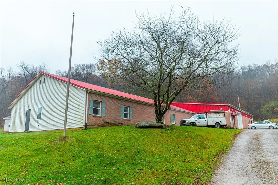 View of side of home featuring a yard