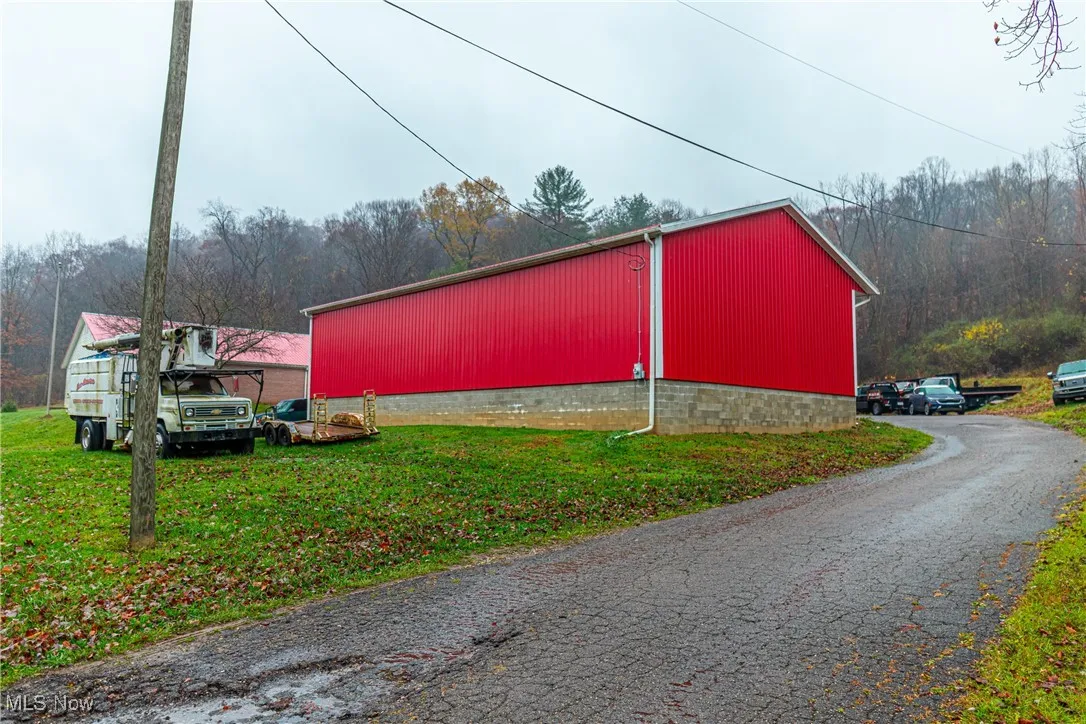 View of outbuilding with a yard