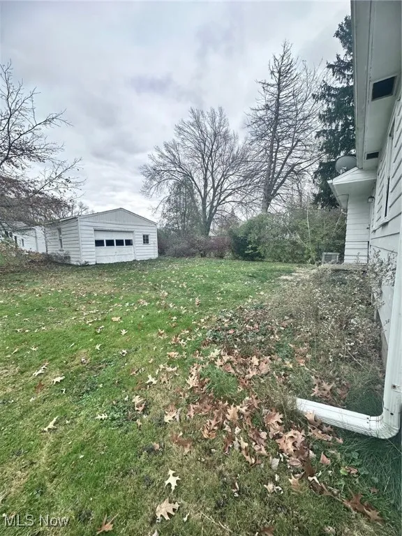 View of yard with an outbuilding and a garage