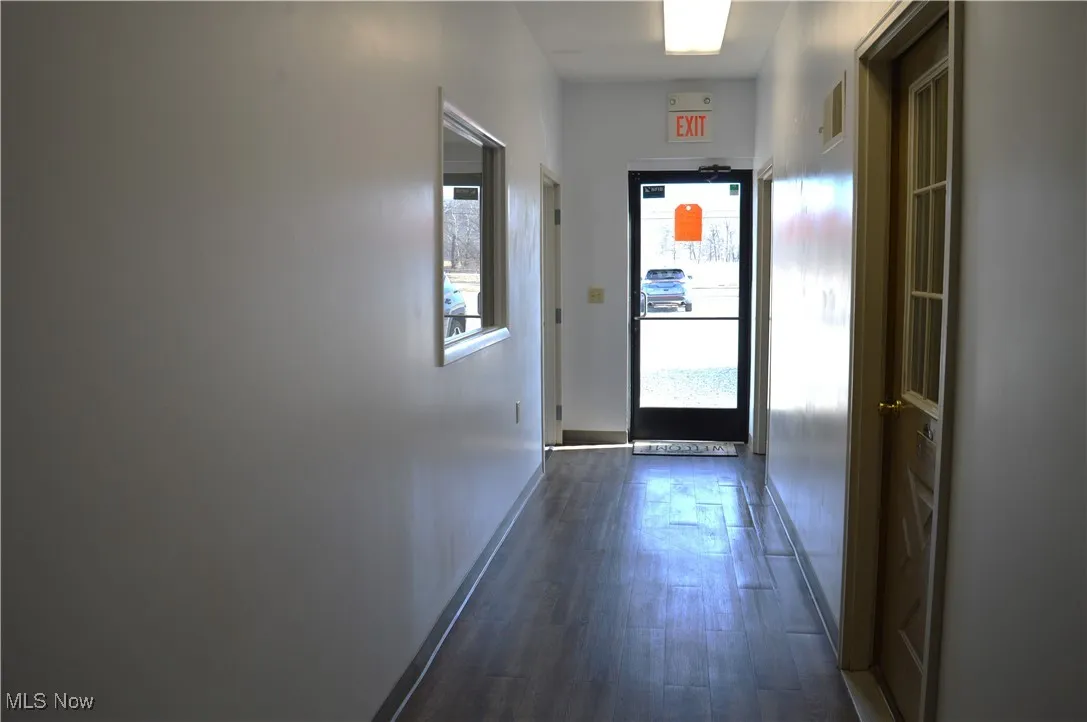 Hall featuring dark wood-type flooring