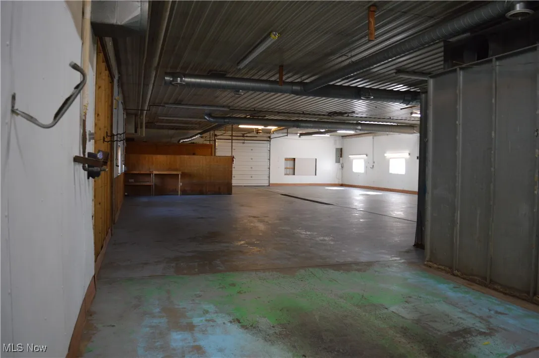 View of garage looking towards the front of the building & Door