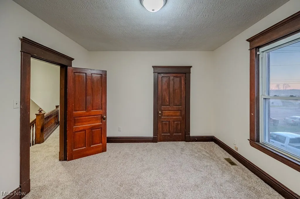 Carpeted bedroom with a textured ceiling