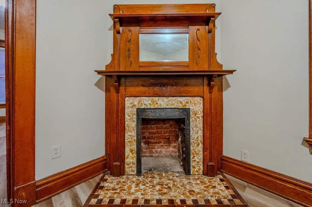Details with a fireplace and wood-type flooring