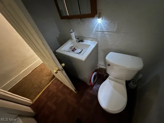 Bathroom with toilet and parquet flooring