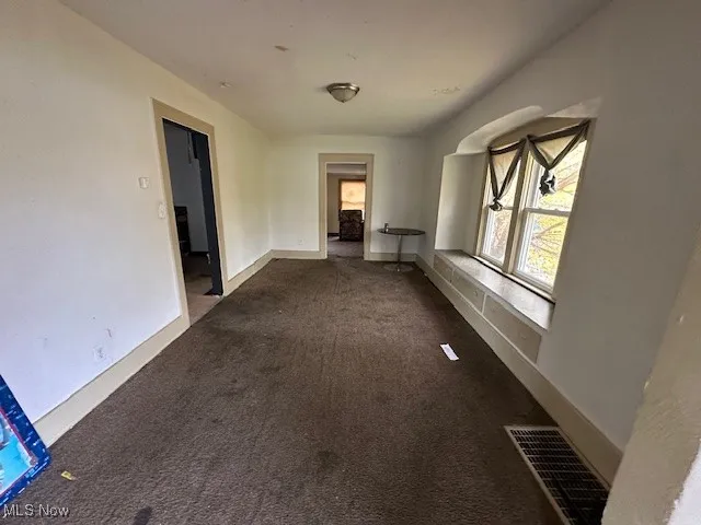 Corridor featuring carpet floors