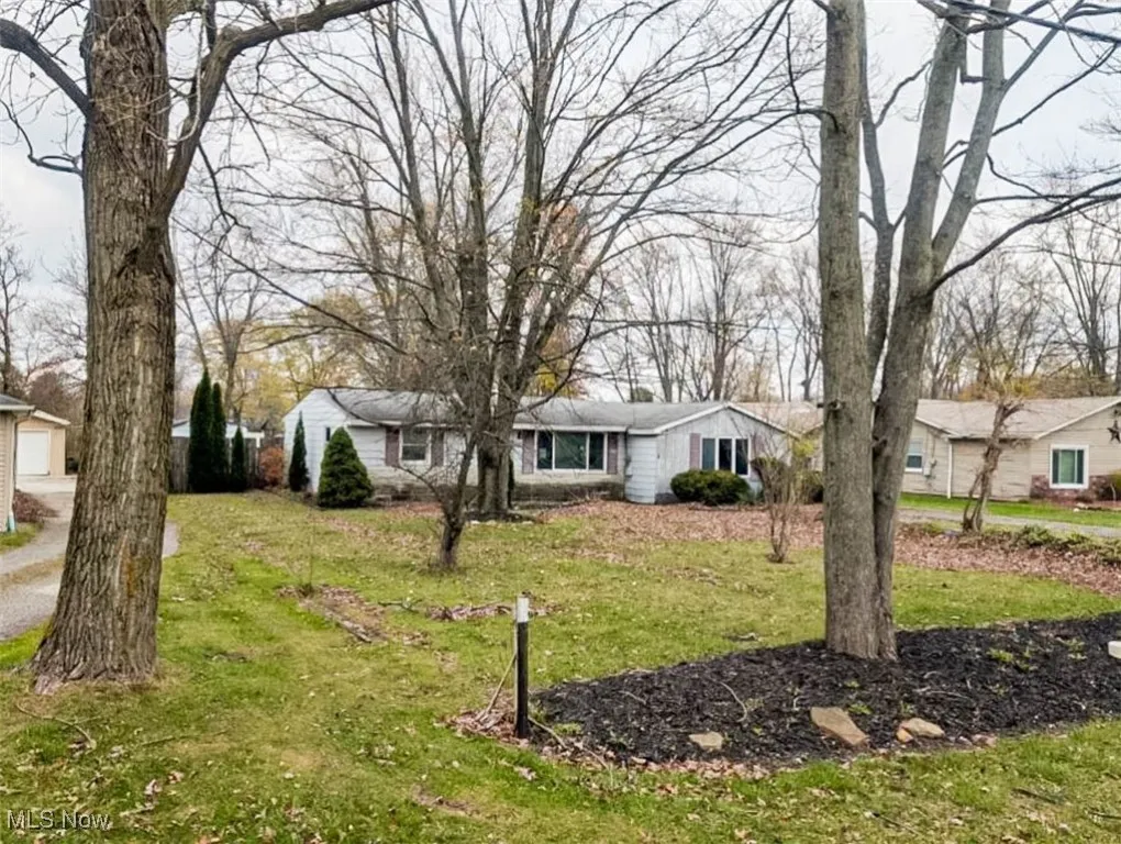 View of front of property featuring a front yard and a garage