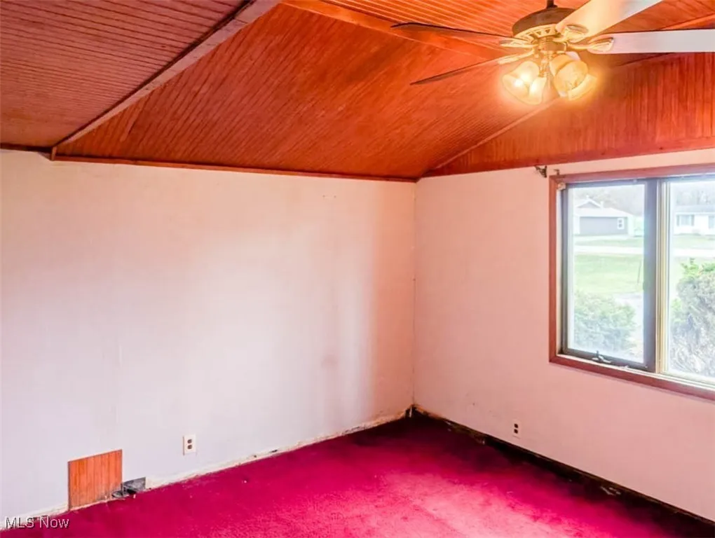 Bonus room with ceiling fan, carpet floors, wooden ceiling, and vaulted ceiling