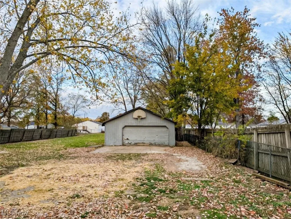 View of yard featuring an outbuilding and a garage
