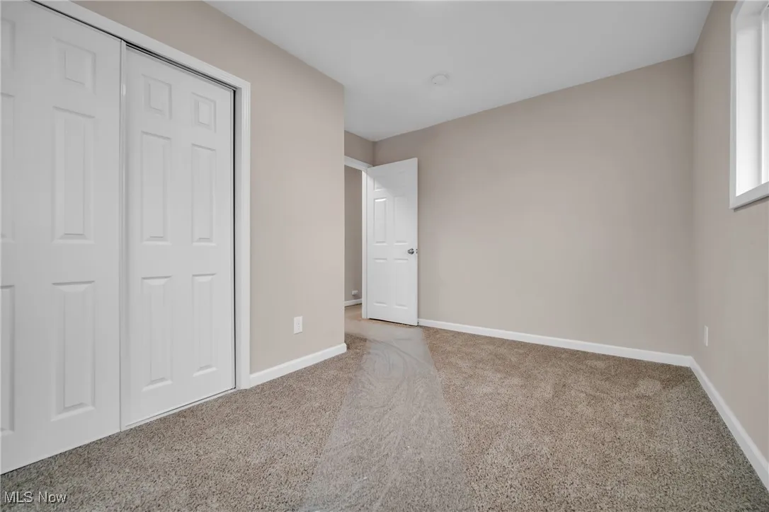 Unfurnished bedroom with carpet floors and a closet