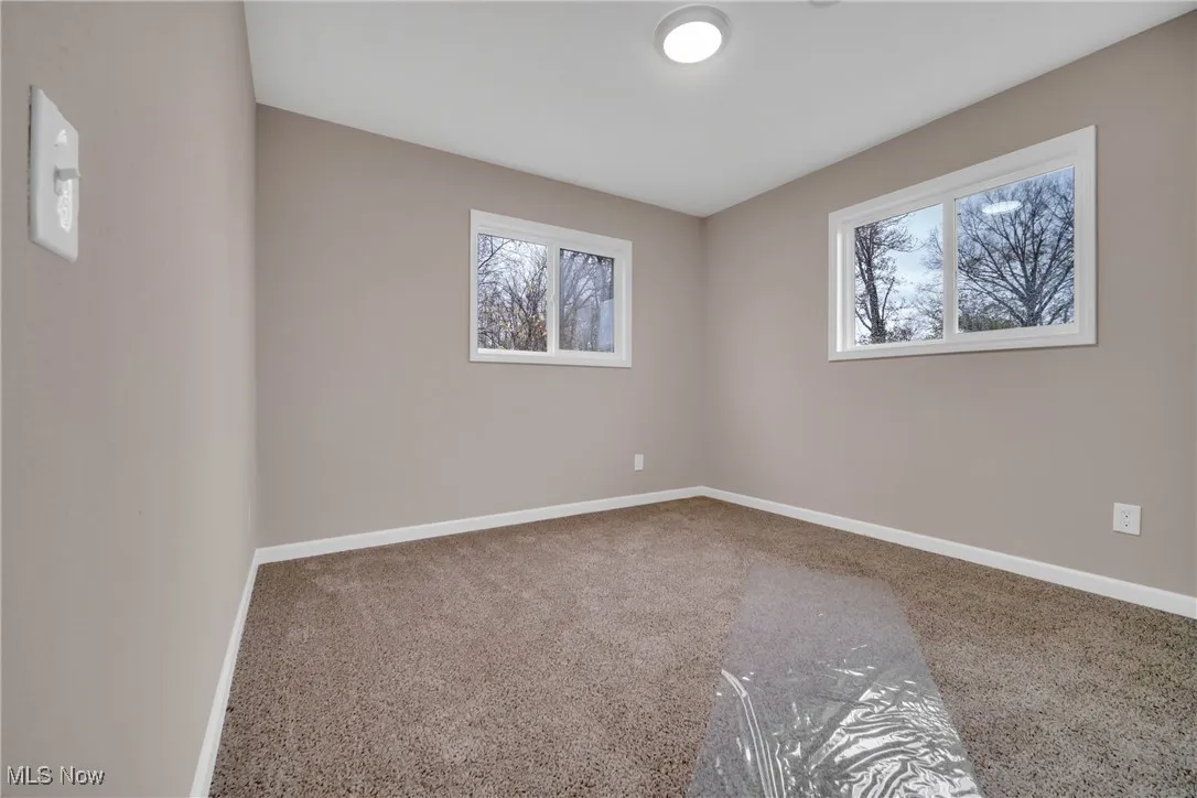 Carpeted empty room with plenty of natural light