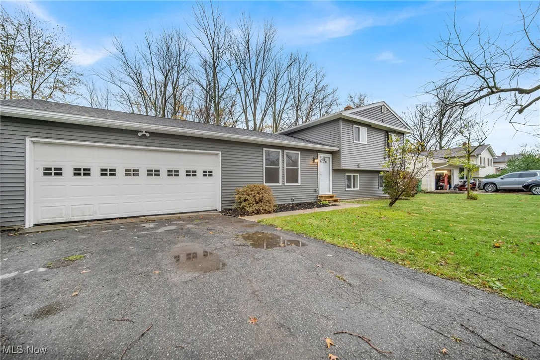 Split-level home with a front lawn and a garage