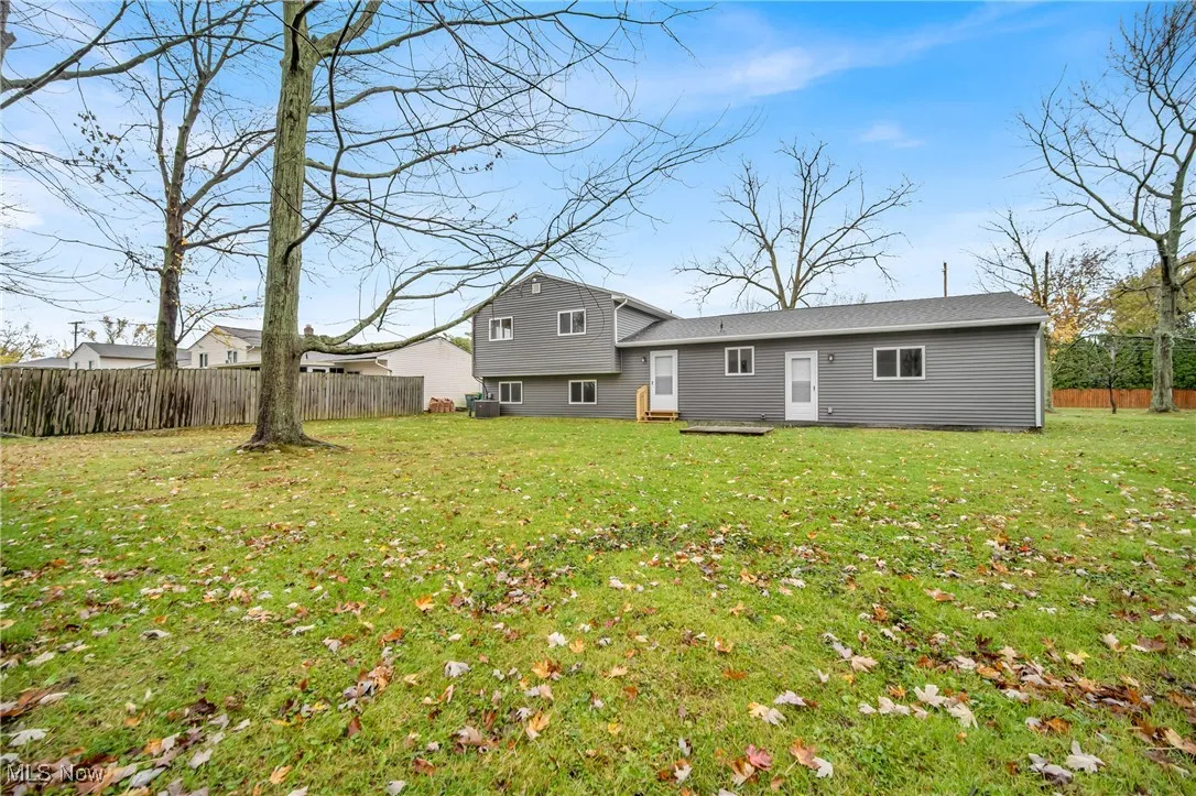 Rear view of property featuring a lawn
