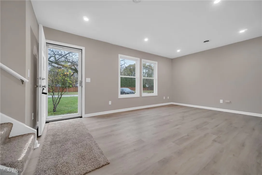Unfurnished living room with light hardwood / wood-style floors