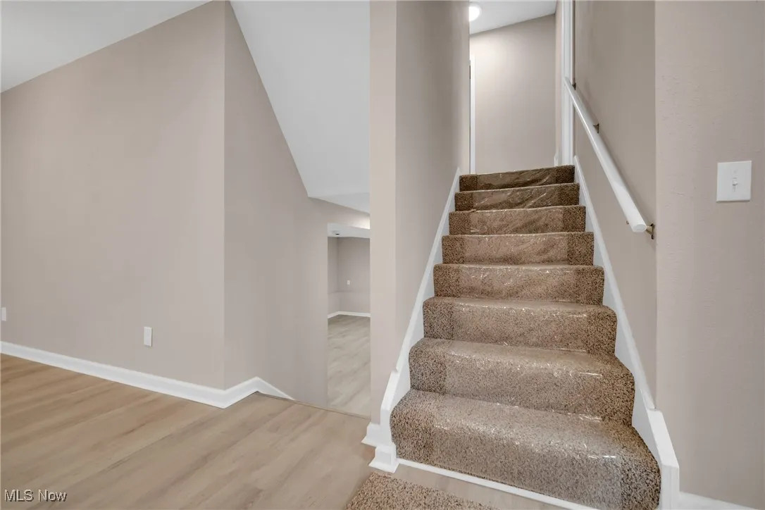 Stairs with hardwood / wood-style floors