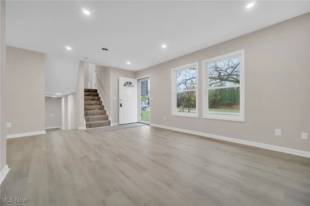 Unfurnished living room with light hardwood / wood-style floors
