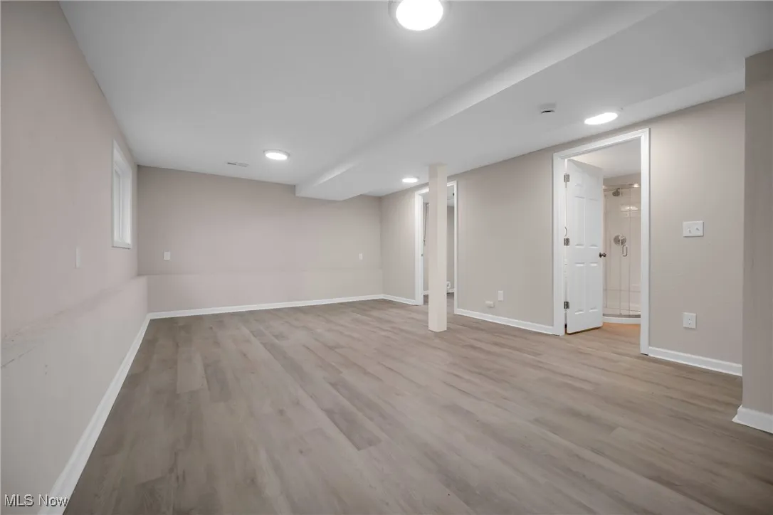 Basement featuring light wood-type flooring
