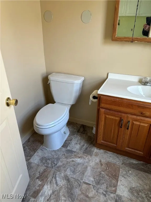 Bathroom featuring vanity and toilet