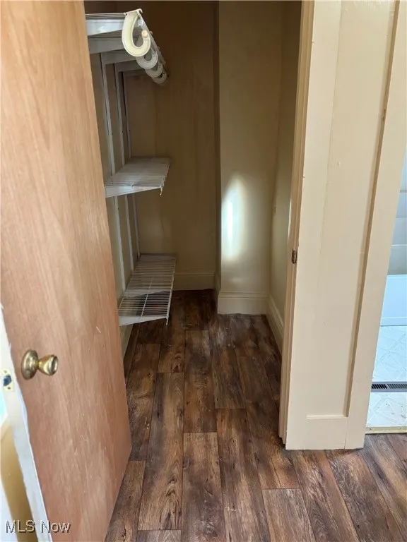 Unfurnished dining area with dark hardwood / wood-style flooring