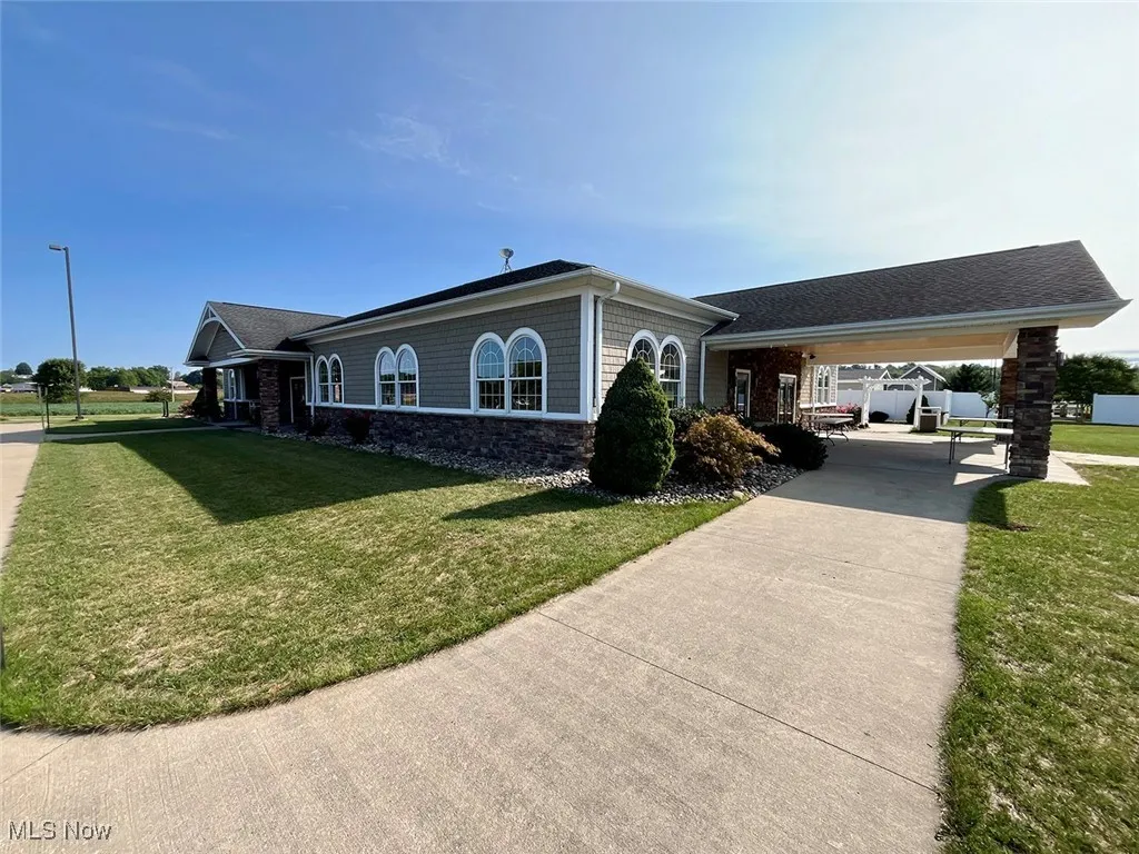View of home's exterior with a carport and a lawn