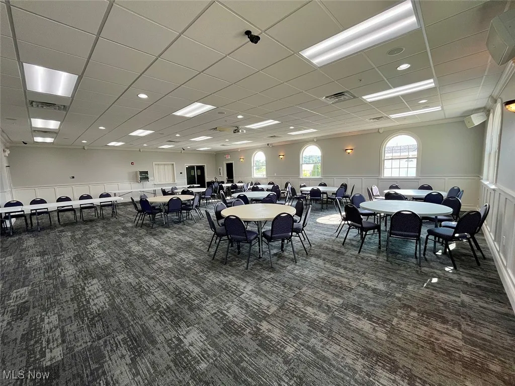 Carpeted dining room with a paneled ceiling
