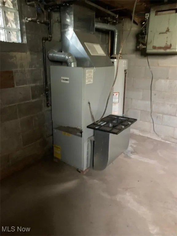 Utility room with gas water heater and electric panel
